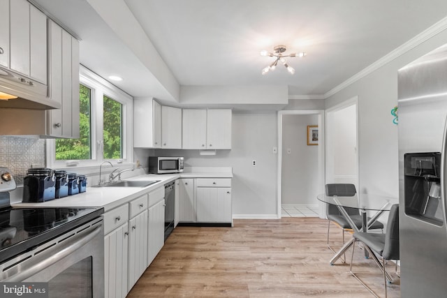 108 Walker Rd, Washington Crossing, PA 18977 - kitchen with stainless steel appliances, light wood-type flooring, light countertops, white cabinetry, and ornamental molding