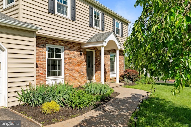 108 Walker Rd, Washington Crossing, PA 18977 - property entrance with a yard, brick siding, and roof with shingles