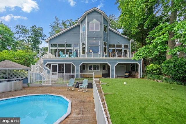 734 Oak Grove Cir, Severna Park, MD 21146 - rear view of house featuring a sunroom, an outdoor pool, a balcony, a yard, and a patio