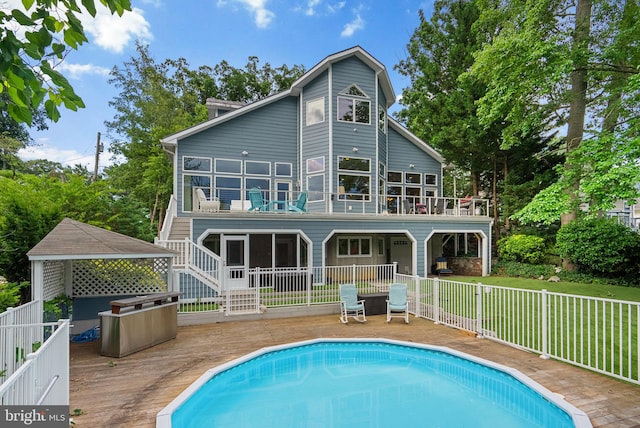 734 Oak Grove Cir, Severna Park, MD 21146 - rear view of house featuring a balcony and a wooden deck