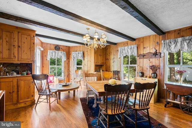 13321 Travilah Rd, Potomac, MD 20854 - dining area with beamed ceiling, wood finished floors, wood walls, and a chandelier