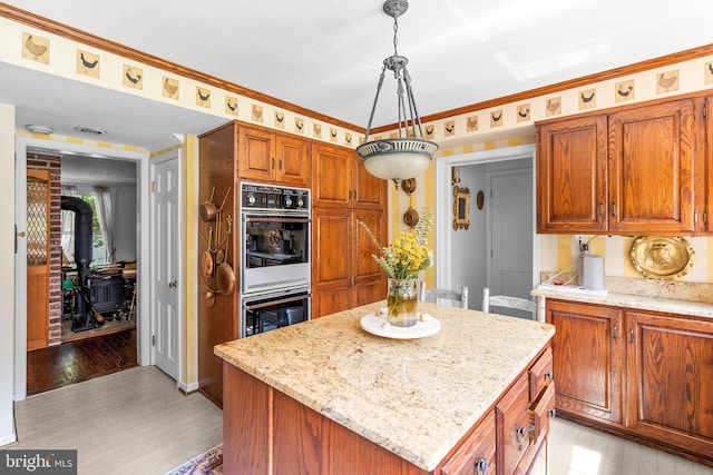 13321 Travilah Rd, Potomac, MD 20854 - kitchen with a wood stove, light wood-style flooring, and light stone countertops