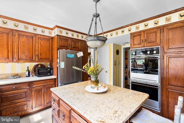 13321 Travilah Rd, Potomac, MD 20854 - kitchen with freestanding refrigerator, white double oven, brown cabinetry, a kitchen island, and light stone counters