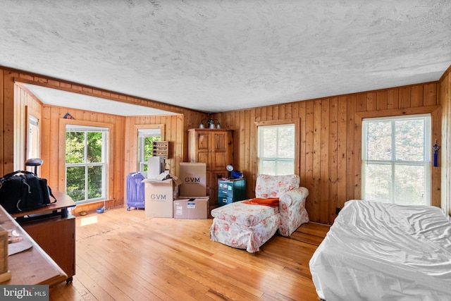 13321 Travilah Rd, Potomac, MD 20854 - bedroom featuring hardwood / wood-style flooring, a textured ceiling, and wooden walls
