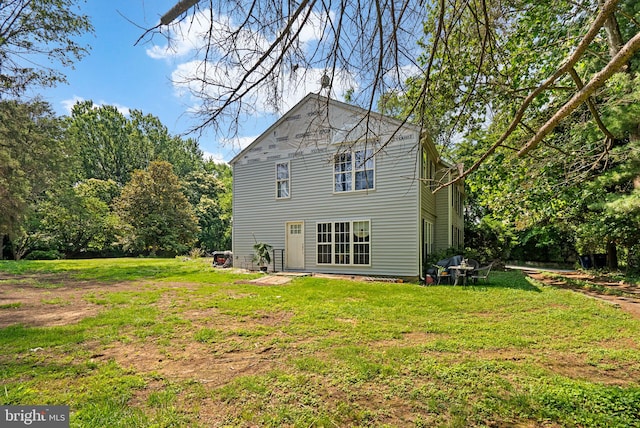 13321 Travilah Rd, Potomac, MD 20854 - rear view of house featuring a lawn