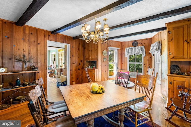 13321 Travilah Rd, Potomac, MD 20854 - dining room featuring wood finished floors, beamed ceiling, wooden walls, a chandelier, and a textured ceiling