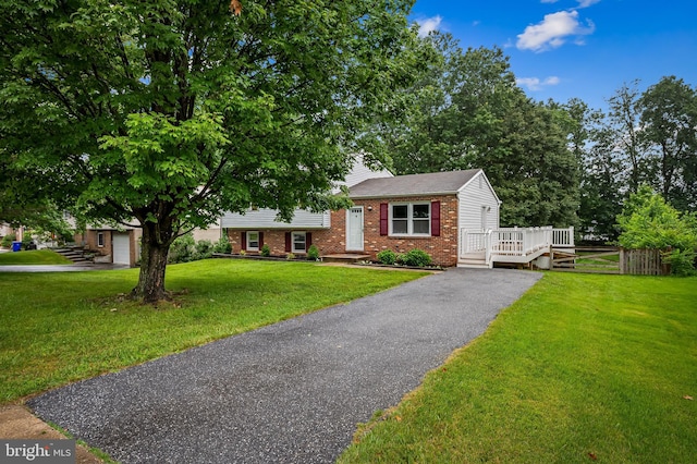 5315 Debbie Ct, Ellicott City, MD 21043 - tri-level home featuring brick siding, driveway, a front yard, and a deck