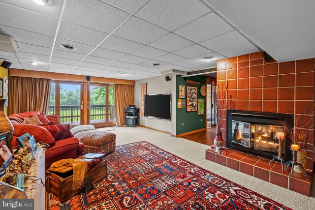 16 Golfview Ln, Reading, PA 19606 - living room featuring carpet, a tiled fireplace, french doors, and a paneled ceiling