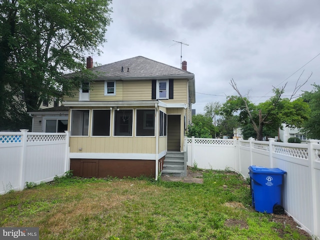301 Heulings Ave, Riverside, NJ 08075 - back of property with a chimney, a sunroom, and roof with shingles