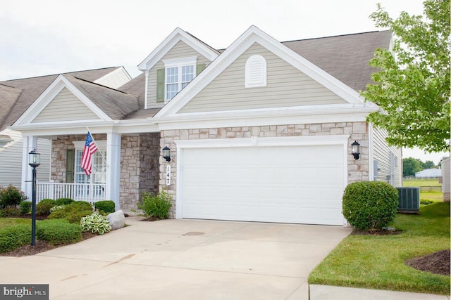 147 Saddletop Dr Unit 381, Taneytown, MD 21787 - view of front facade featuring stone siding, concrete driveway, a garage, and a porch