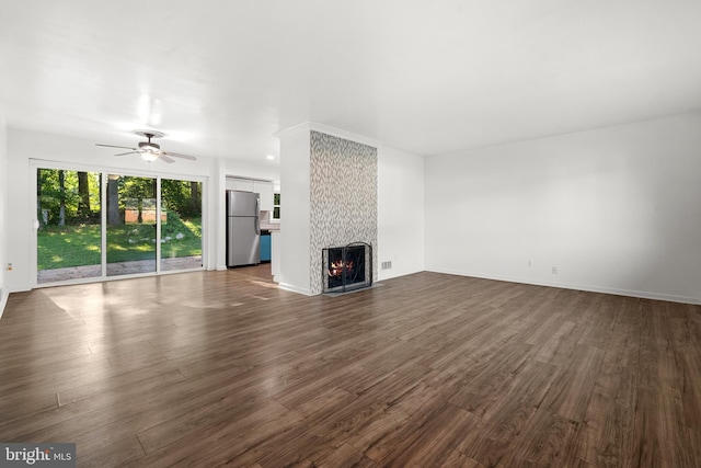 5505 Heming Ave, Springfield, VA 22151 - unfurnished living room featuring dark wood-style flooring, a ceiling fan, and a fireplace
