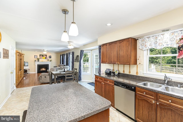 6 Oxen Ct, Stafford, VA 22554 - kitchen featuring dishwasher, a warm lit fireplace, a ceiling fan, hanging light fixtures, and brown cabinets