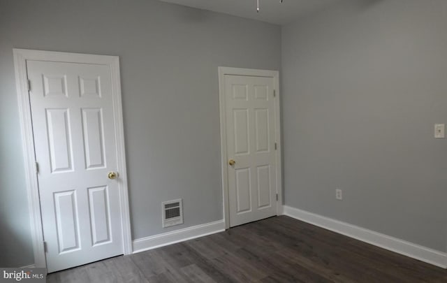 3124 N Carlisle St, Philadelphia, PA 19132 - unfurnished bedroom featuring dark wood-style floors and baseboards