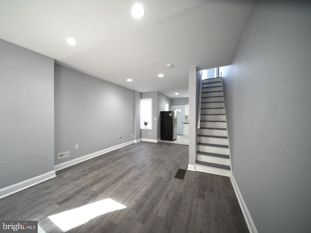 3124 N Carlisle St, Philadelphia, PA 19132 - unfurnished living room featuring dark wood-style flooring, stairway, and recessed lighting