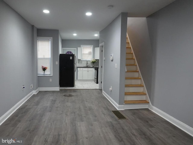 3124 N Carlisle St, Philadelphia, PA 19132 - unfurnished living room with dark wood-type flooring, stairs, and recessed lighting