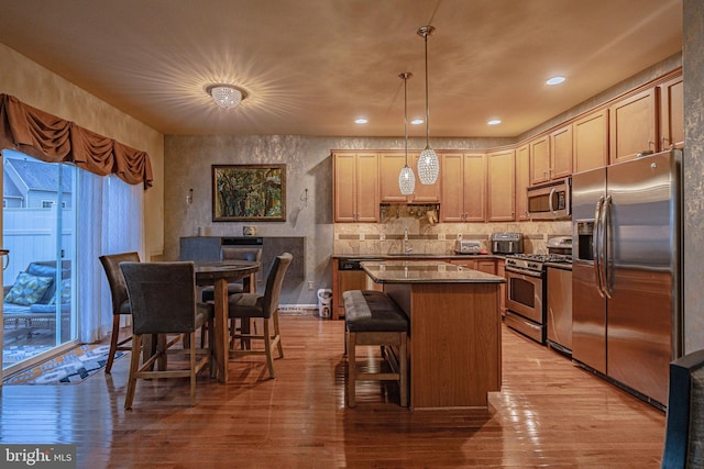4549 Woodbrush Way, Allentown, PA 18104 - kitchen featuring stainless steel appliances, a center island, light wood-style floors, dark countertops, and recessed lighting