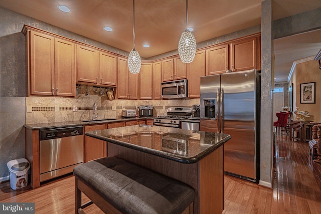 4549 Woodbrush Way, Allentown, PA 18104 - kitchen featuring appliances with stainless steel finishes, light wood-style floors, dark stone countertops, backsplash, and recessed lighting