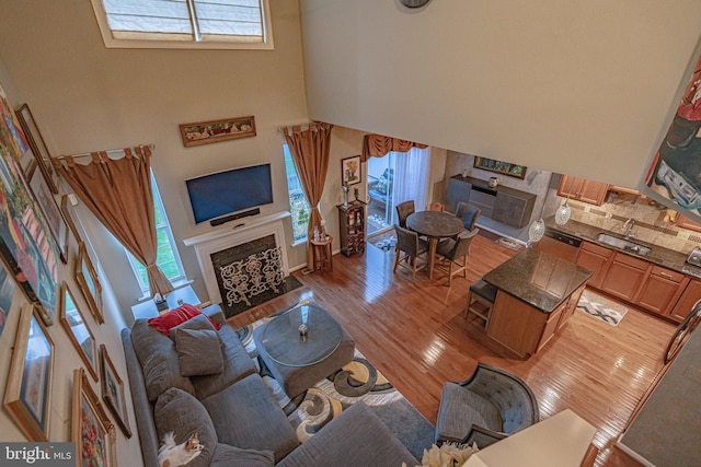 4549 Woodbrush Way, Allentown, PA 18104 - living room with a fireplace with flush hearth, a high ceiling, and light wood-type flooring