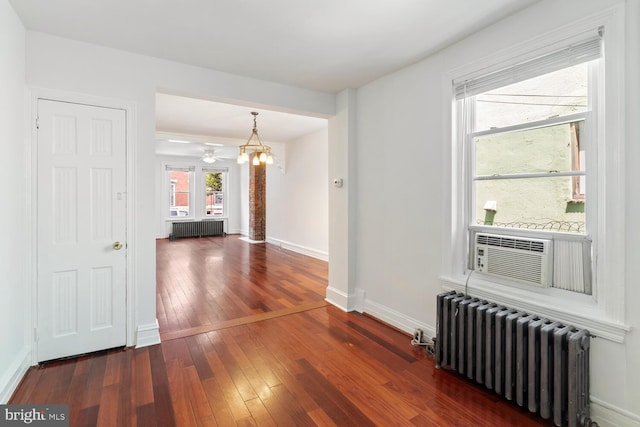 1615 S 16th St, Philadelphia, PA 19145 - empty room featuring radiator heating unit, hardwood / wood-style flooring, a chandelier, and cooling unit