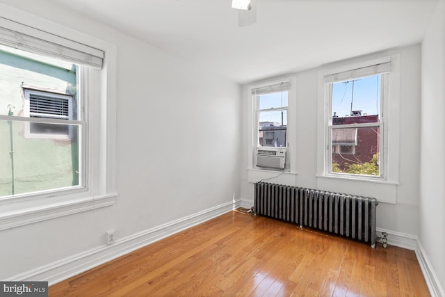 1615 S 16th St, Philadelphia, PA 19145 - spare room featuring radiator, light wood-style flooring, and cooling unit