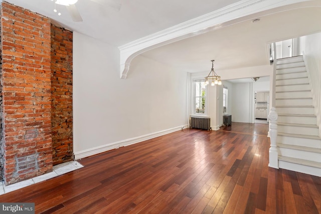 1615 S 16th St, Philadelphia, PA 19145 - unfurnished living room with radiator, arched walkways, stairway, hardwood / wood-style floors, and ceiling fan