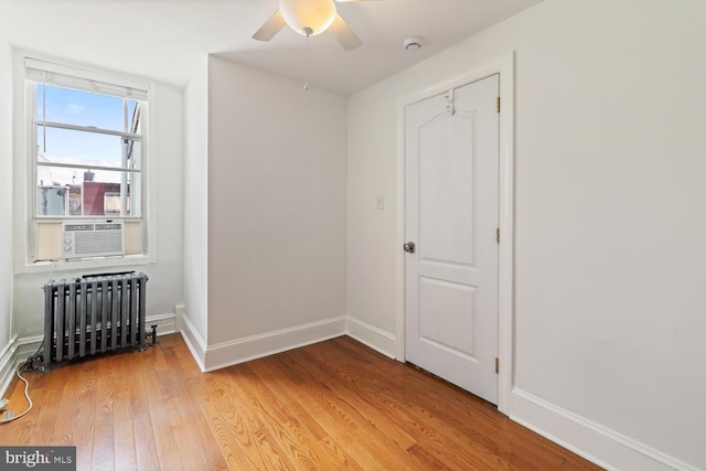 1615 S 16th St, Philadelphia, PA 19145 - spare room featuring radiator heating unit, cooling unit, a smoke detector, a ceiling fan, and light wood finished floors