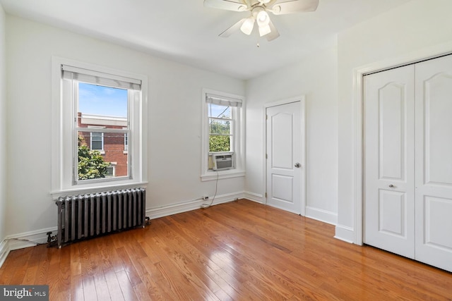 1615 S 16th St, Philadelphia, PA 19145 - unfurnished bedroom with radiator heating unit, light wood-style flooring, cooling unit, and a ceiling fan
