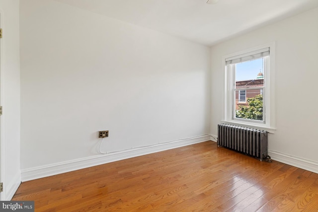 1615 S 16th St, Philadelphia, PA 19145 - unfurnished room featuring radiator heating unit and wood finished floors