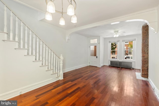 1615 S 16th St, Philadelphia, PA 19145 - unfurnished living room featuring radiator, arched walkways, hardwood / wood-style floors, a chandelier, and a ceiling fan