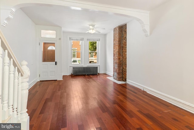1615 S 16th St, Philadelphia, PA 19145 - foyer featuring radiator, hardwood / wood-style floors, a ceiling fan, arched walkways, and stairs