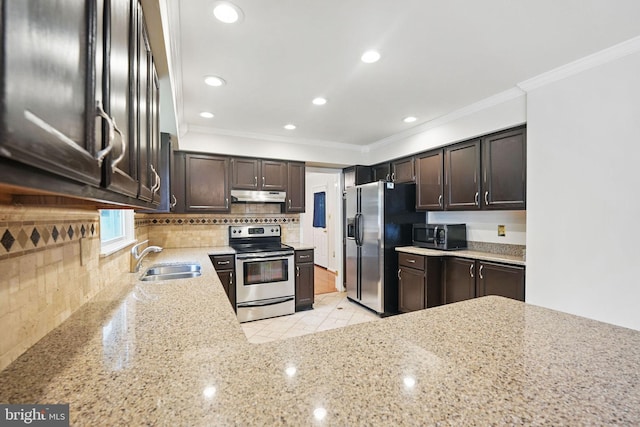 4009 Gypsum Hill Rd, Haymarket, VA 20169 - kitchen featuring stainless steel appliances, under cabinet range hood, light stone countertops, crown molding, and dark brown cabinets
