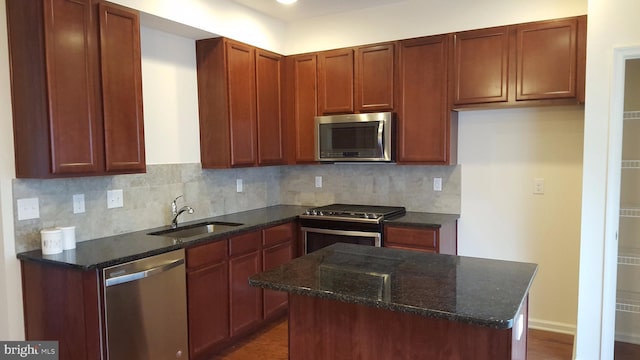 3711 Jacob Stout Rd Unit 7, Doylestown, PA 18902 - kitchen featuring appliances with stainless steel finishes, dark stone counters, tasteful backsplash, a kitchen island, and dark wood finished floors