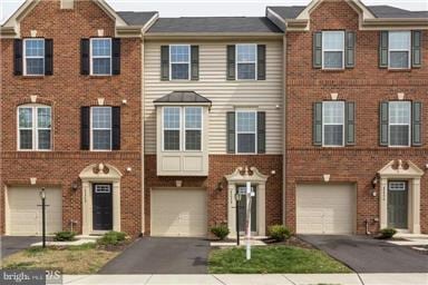 45952 Iron Oak Ter, Sterling, VA 20166 - townhome / multi-family property with driveway, brick siding, and a garage