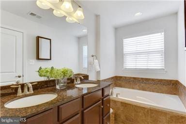 45952 Iron Oak Ter, Sterling, VA 20166 - full bathroom featuring double vanity, a garden tub, and a chandelier