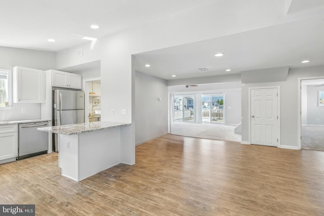 83 Morton Dr, Manahawkin, NJ 08050 - kitchen with appliances with stainless steel finishes, recessed lighting, light wood-style floors, white cabinets, and light stone countertops