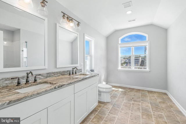 83 Morton Dr, Manahawkin, NJ 08050 - bathroom featuring double vanity, lofted ceiling, tiled shower, and stone finish flooring