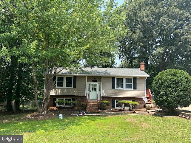 6035 Loriella Park Dr, Fredericksburg, VA 22407 - split foyer home with a chimney, a front lawn, and entry steps