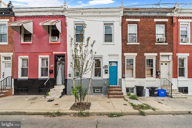 2230 Watkins St, Philadelphia, PA 19145 - townhome / multi-family property featuring entry steps, brick siding, and cooling unit