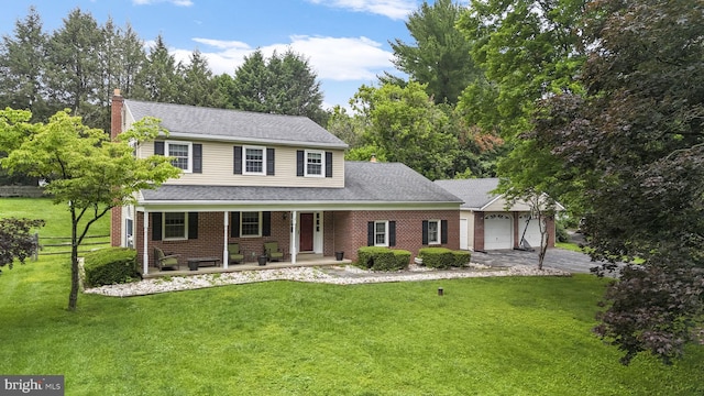 1559 Washington Ln, West Chester, PA 19382 - traditional-style house with an attached garage, a porch, a chimney, asphalt driveway, and brick siding