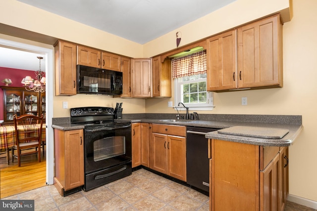 1559 Washington Ln, West Chester, PA 19382 - kitchen featuring black appliances, dark countertops, a chandelier, and brown cabinets