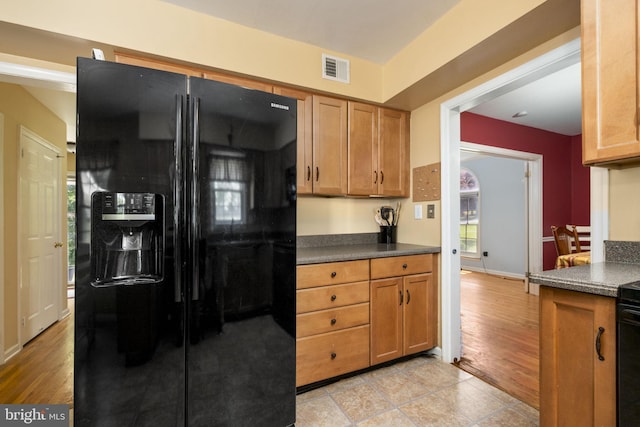 1559 Washington Ln, West Chester, PA 19382 - kitchen featuring black fridge, dark countertops, and brown cabinets