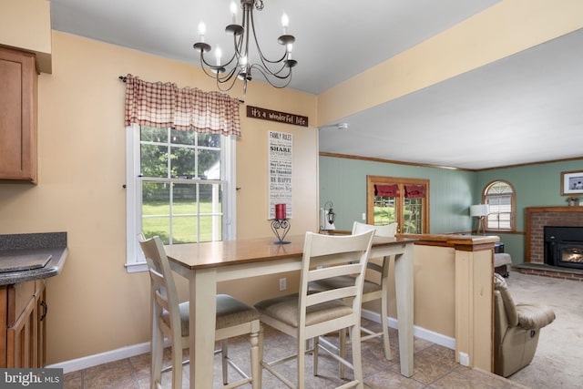 1559 Washington Ln, West Chester, PA 19382 - dining area featuring a chandelier, crown molding, and a brick fireplace