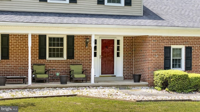 1559 Washington Ln, West Chester, PA 19382 - doorway to property featuring a shingled roof, brick siding, and covered porch