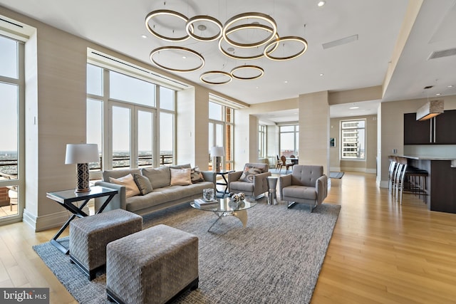 130 S 18th St Unit 3102, Philadelphia, PA 19103 - living area featuring light wood-style flooring, ornate columns, a chandelier, and recessed lighting