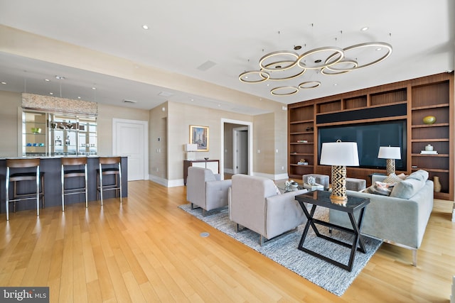 130 S 18th St Unit 3102, Philadelphia, PA 19103 - living area featuring a chandelier, light wood finished floors, built in features, and recessed lighting