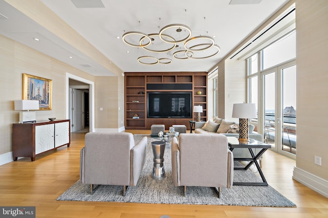 130 S 18th St Unit 3102, Philadelphia, PA 19103 - living area featuring light wood-style flooring, a chandelier, built in shelves, and recessed lighting