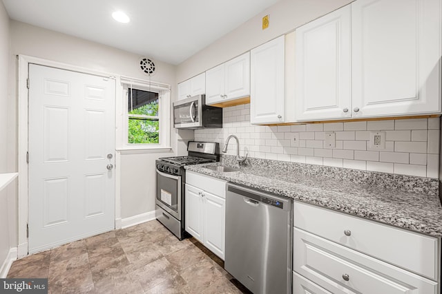 838 Benninghaus Rd, Baltimore, MD 21212 - kitchen featuring stainless steel appliances, backsplash, white cabinetry, and light stone counters