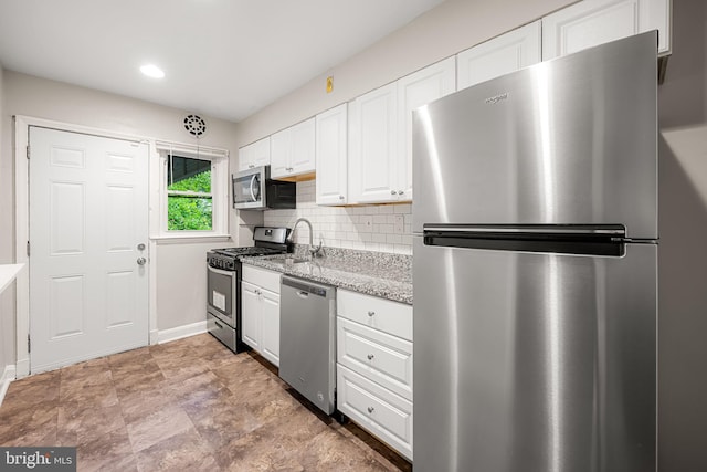 838 Benninghaus Rd, Baltimore, MD 21212 - kitchen with stainless steel appliances, white cabinets, decorative backsplash, light stone countertops, and recessed lighting