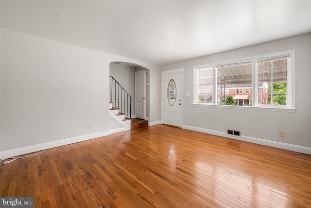 838 Benninghaus Rd, Baltimore, MD 21212 - entrance foyer with arched walkways, hardwood / wood-style floors, and stairway