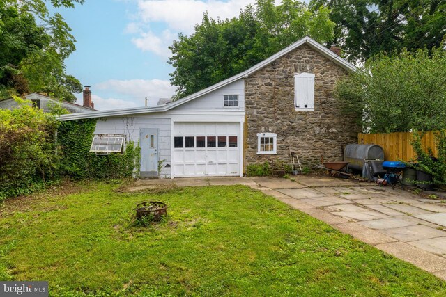 1806 Graham Ln, Elkins Park, PA 19027 - view of property exterior featuring stone siding, a garage, concrete driveway, and a chimney